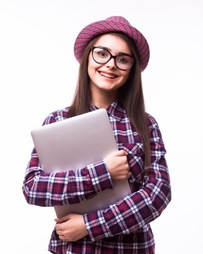 Young smiling confident woman using laptop computer and looking camera isolated over white